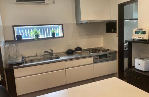 Amami House | Guesthouse Naze: Family-Friendly Stay with Kitchen Access