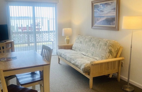 Chincoteague Cottage | Cozy Snug Harbor Waterfront Cottage with Lighthouse Views