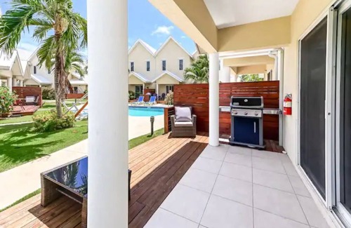 West Bay House | Cozy Condo with Pool and Ocean View, Steps from the Beach