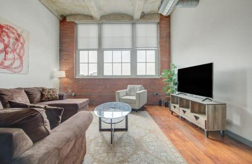 Crossroads Arts District Apartment | Inviting Historic Loft with Gym for Family Stays by ENVITAE
