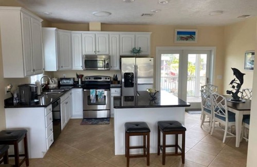 Breezeswept Beach Estates House | Exquisite Two-Story Home with Pool & Dock Access