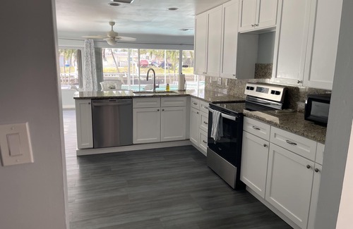 Yacht Club House | Elegant 3BR Canal Retreat with Heated Pool & Ocean Views