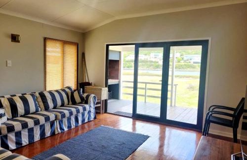 Still Bay House | Charming Riverfront Escape: A Rickety River House Awaits