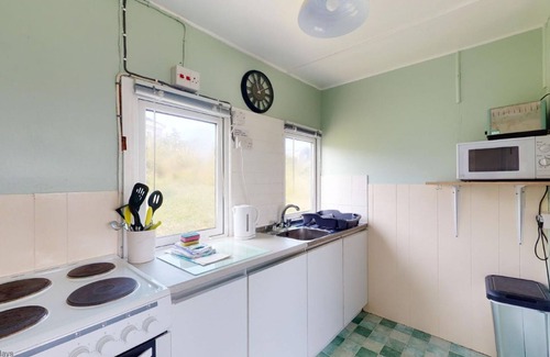 Hayle Apartment | A traditional beach chalet vibe, and outdoor seating with views toward St. Ives Bay