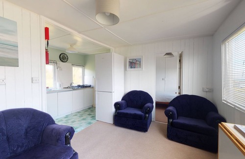 Hayle Apartment | A traditional beach chalet vibe, and outdoor seating with views toward St. Ives Bay
