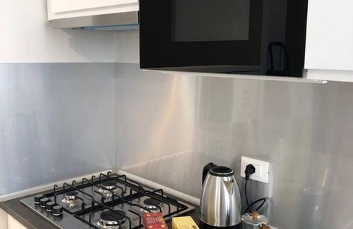 Case Peschiera-Lu Fraili Apartment | Enjoy Modern Comforts with a Flat-Screen TV in Your Room