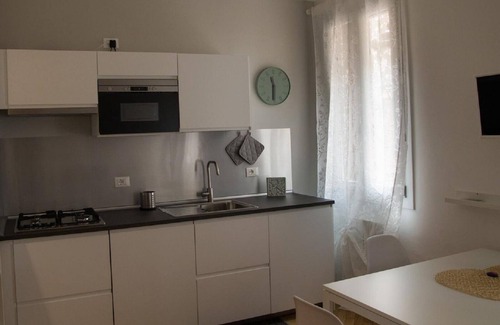 Case Peschiera-Lu Fraili Apartment | Enjoy Modern Comforts with a Flat-Screen TV in Your Room