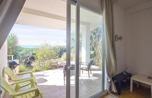 Punta Braccetto House | Unwind by the Water: Relaxing Garden Retreat with Spa