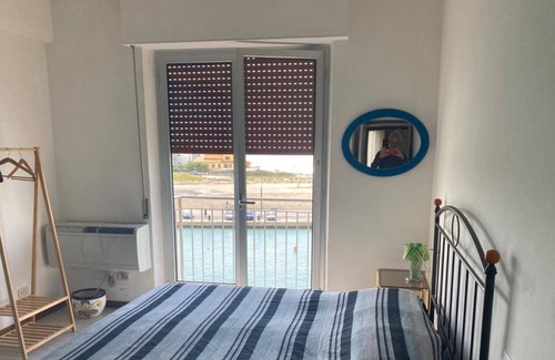 Castiglione della Pescaia Apartment | Canal View Apartment - Family-Friendly with Kitchen Access