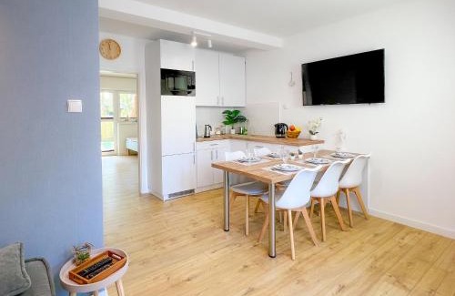 Poddabie Apartment | Experience Blue Marine Poddąbie: Poolside Family Retreat