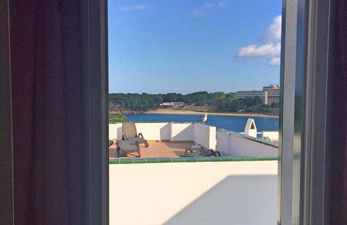 Arenal d'en Castell Apartment | Oceanfront Apartment with Pool and Stunning Sea Views
