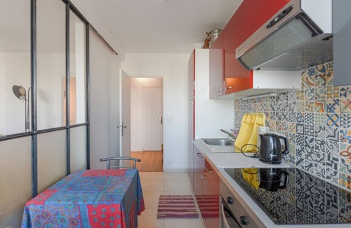 Clichy Apartment | Inviting Retreat with Balcony and Seine River Views