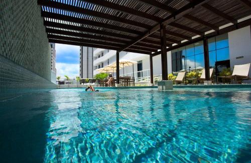 Caminho das Arvores Hotel | Discover Astron Suítes Mondial Salvador: Beachfront Bliss