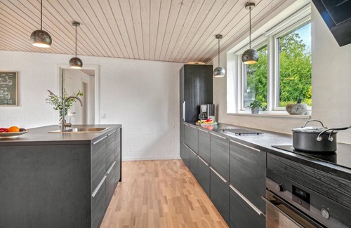 Grena Strand House | Cozy Cottage with Family-Friendly Outdoor Space and Ocean Views