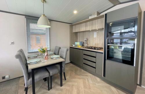 Lockerbie House | Tranquil Lakeside Lodge with Hot Tub and Scenic Views