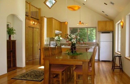 Butte Ski Chalet | Inviting Riverfront Retreat with Hot Tub & Ocean Views