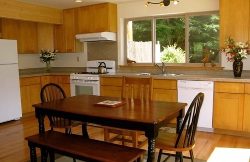 Butte Ski Chalet | Inviting Riverfront Retreat with Hot Tub & Ocean Views