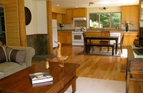 Butte Ski Chalet | Inviting Riverfront Retreat with Hot Tub & Ocean Views