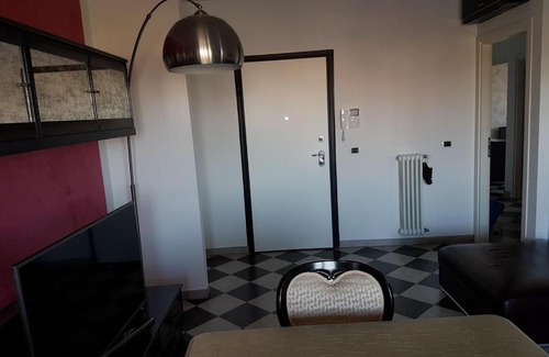 Granarolo dell'Emilia Apartment | Modern Black and White Apartment with Family-Friendly Amenities