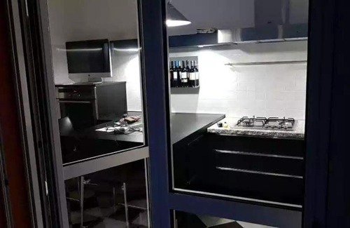 Granarolo dell'Emilia Apartment | Modern Black and White Apartment with Family-Friendly Amenities