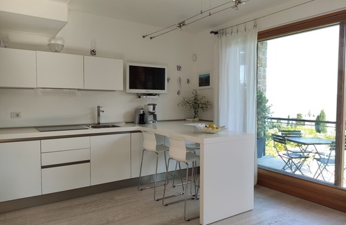 Cecina Apartment | Scenic Lake View Apartment with Free Wi-Fi & Pool Access