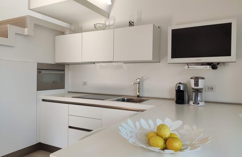 Cecina Apartment | Scenic Lake View Apartment with Free Wi-Fi & Pool Access