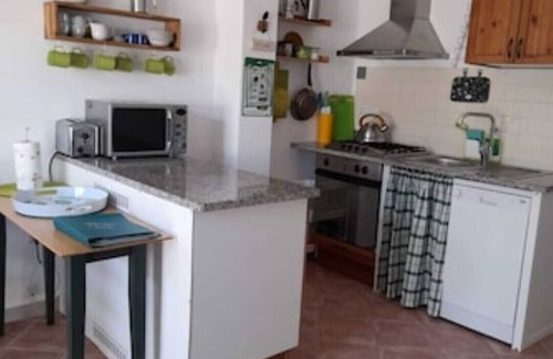 Cabras Apartment | Cozy BRIDI Holiday Home with Oceanfront Views & Pool