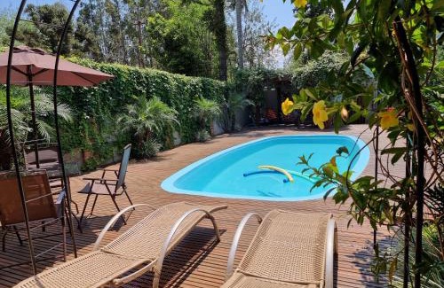Foz do Iguacu Ski Chalet | Palm-Surrounded Casa do Mato near Iguassu Falls with Pool