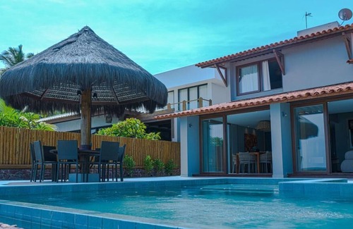 Barra de Sao Miguel House | CasaB standing on the sand in Barra.