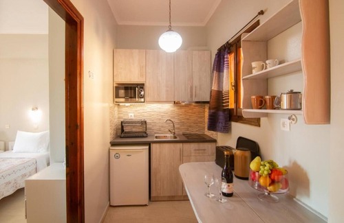 Roda Apartment | Central apartments amidst flower gardens with pool access, 120m from the beach