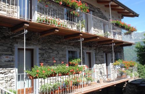 Inverso Pinasca Apartment | Cozy Stone and Wood Chalet with Fireplace & Family Amenities