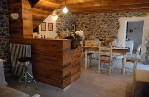Inverso Pinasca Apartment | Cozy Stone and Wood Chalet with Fireplace & Family Amenities