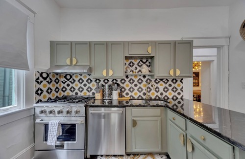 Inman Park Apartment | Charming 2BR/2BA lower-level unit in a classic Inman Park duplex. Features full kitchen, cozy living area with fireplace, Southern-style front porch, clawfoot tub, in-unit laundry, and dedicated parking. Walkable to dining and MARTA.