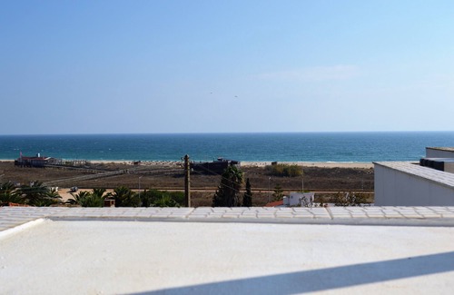 Meia Praia Apartment | Scenic Apartment with Rooftop Terrace Near Beach & Dining