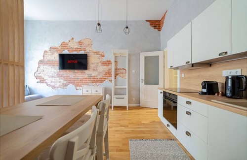 Nove Mesto Apartment | Chic Brick Suite in Historic City