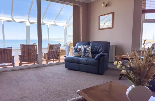 Borth House | Cliff Haven: Oceanfront Retreat with Pet-Friendly Amenities
