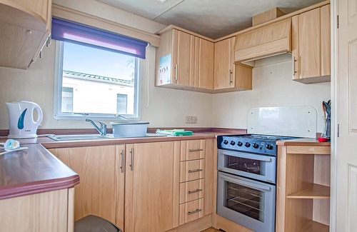Llanllwchaiarn House | Inviting Caravan with Pool and Oceanfront Views