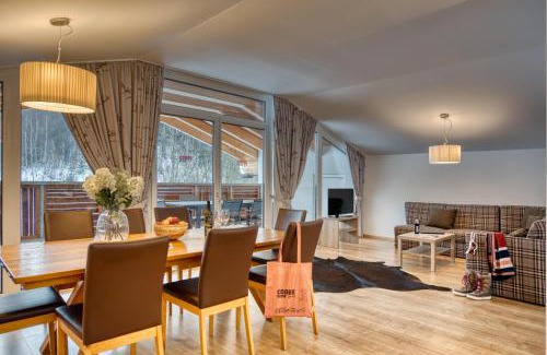 Sankt Johann in Tirol Hotel | Discover COOEE alpin Hotel: Spa & Hot Tub Retreat