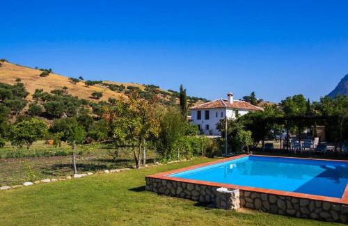 Grazalema House | Elegant Cortijo Grazalema: Poolside Retreat for Families