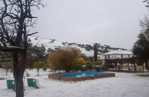 Grazalema House | Elegant Cortijo Grazalema: Poolside Retreat for Families