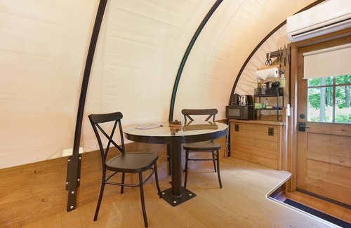 Strasburg RV Rental | Idyllic Covered Wagon Camping Experience by the Creek