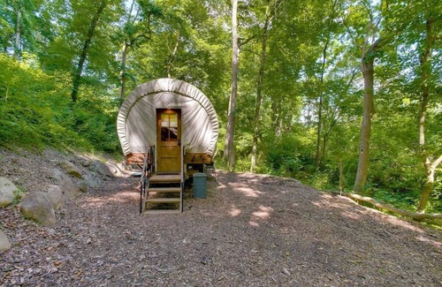Strasburg RV Rental | Idyllic Covered Wagon Camping Experience by the Creek