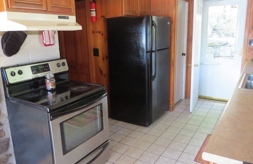 Weare Cottage | Charming Lakefront Cottage with Pool and Hot Tub
