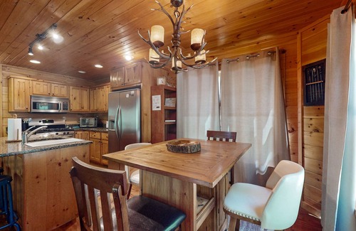 Cherry Log Cabin | Creek Cabin with fenced yard, screened in patio and hot tub