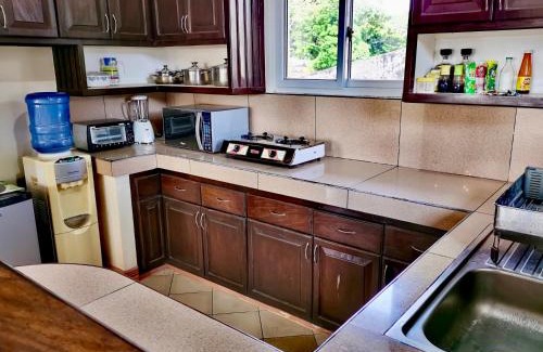 Basco House | Cozy Den Den Guesthouse: Family-Friendly with Kitchen Access
