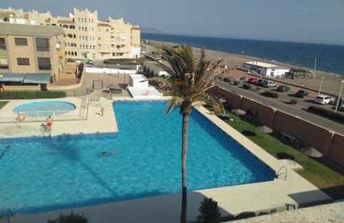Retamar Apartment | Experience El Cuchitril: Oceanfront Haven with Pool