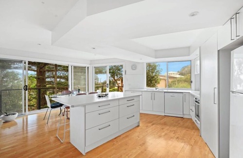 Forresters Beach House | Relax on the Seabreezing Deck with Oceanfront Views