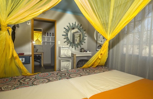Okaukuejo Cabin | Explore Etosha Safari Camp: Family-Friendly Retreat with Pool