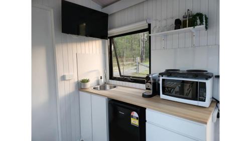 Girvan House | Delight in the Firefly Tiny House - Rated 9.6 by Guests