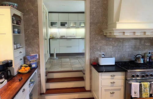 New Canaan House | Inviting Fountain Courtyard with Ocean View & Fireplace Kitchen